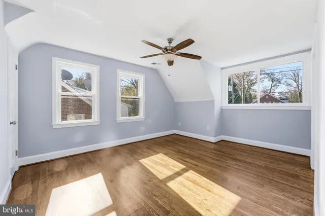 an empty room with windows and bathroom