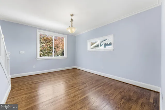 a view of a livingroom with wooden floor and a fireplace