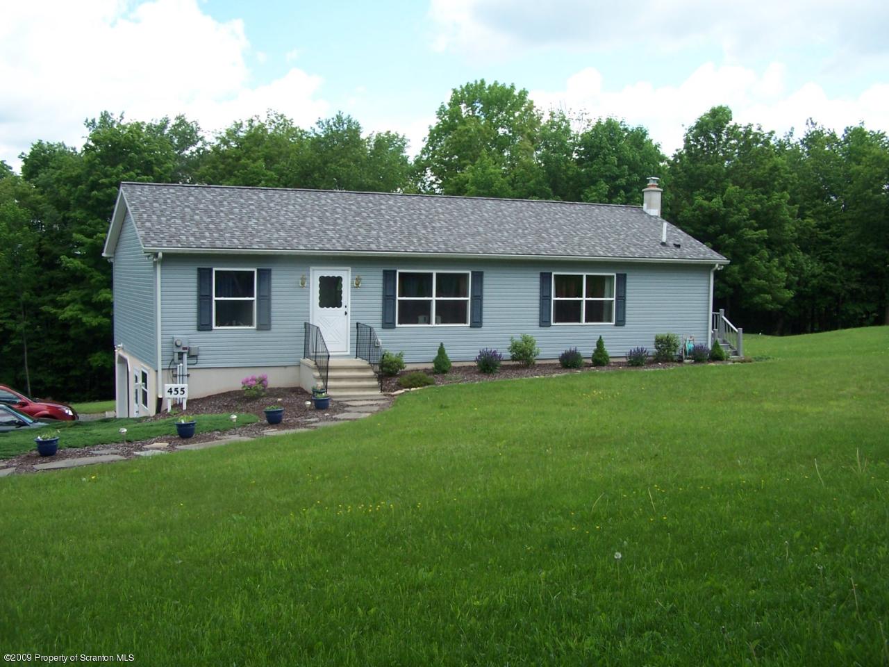455 Maple Grove Road Factoryville, PA 18419 - Photo 1 of 16 a backyard of a house with table and chairs