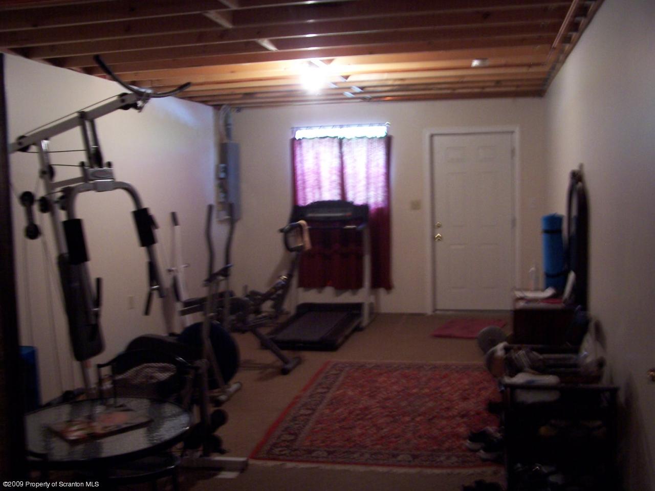 455 Maple Grove Road Factoryville, PA 18419 - Photo 11 of 16 a room with lots of trees and windows