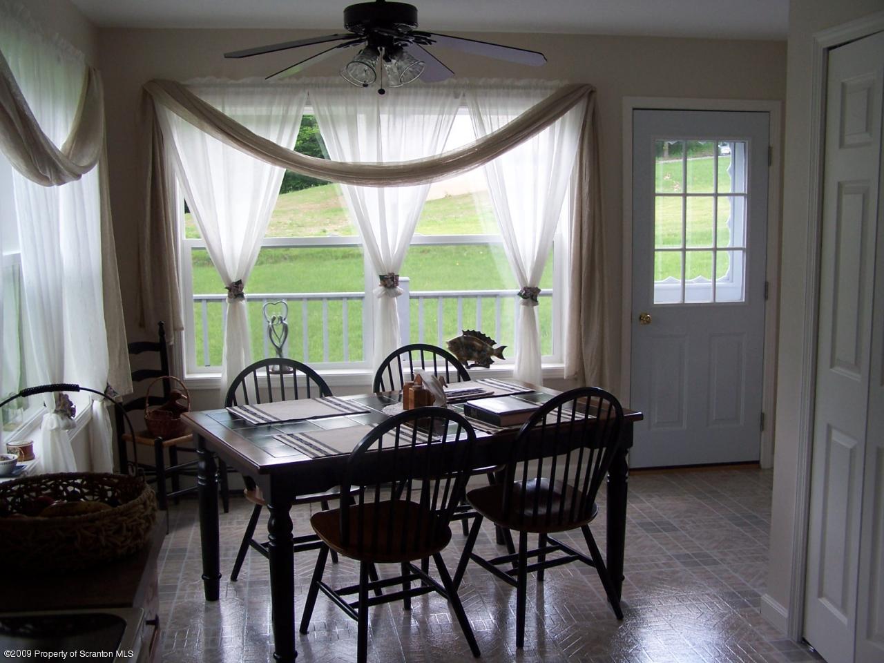 455 Maple Grove Road Factoryville, PA 18419 - Photo 3 of 16 a view of a dining room with furniture window and outside view