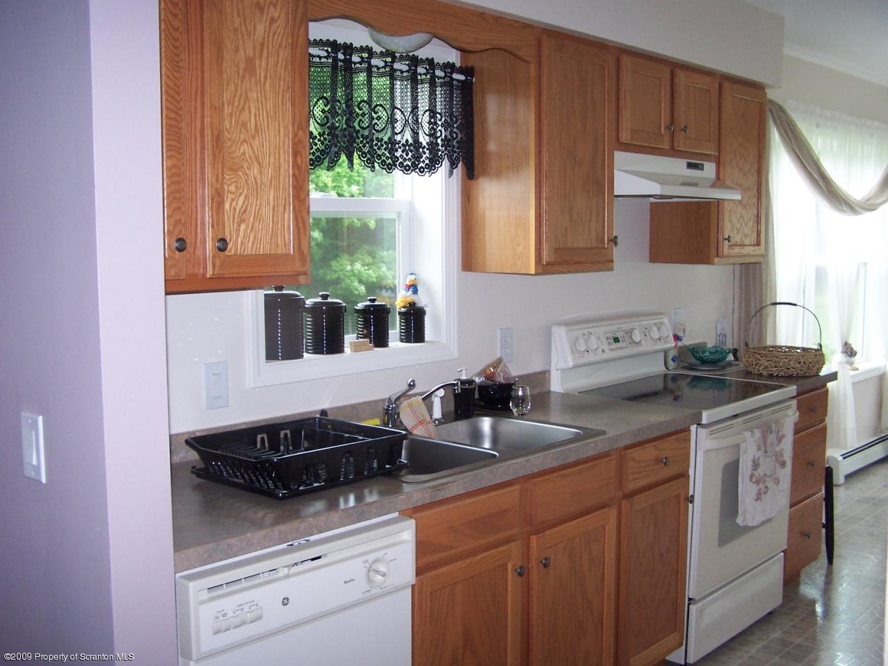 455 Maple Grove Road Factoryville, PA 18419 - Photo 4 of 16 a kitchen with a sink and cabinets