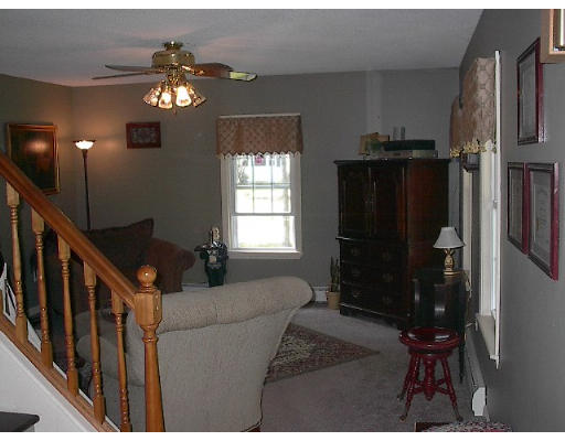 40 Bunyan Road Monson, MA 01057 - Photo 8 of 15 a living room with furniture and a chandelier