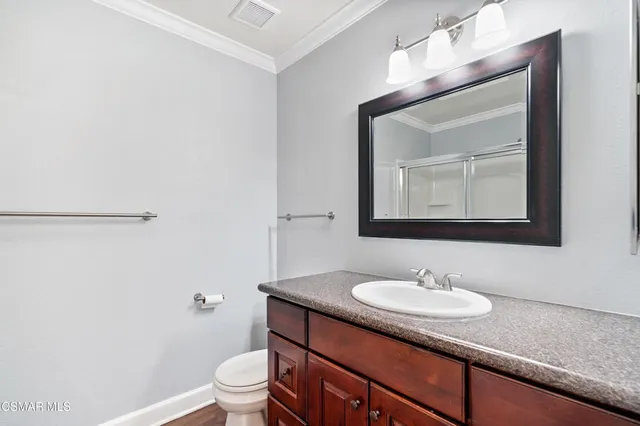 a bathroom with a sink toilet and mirror