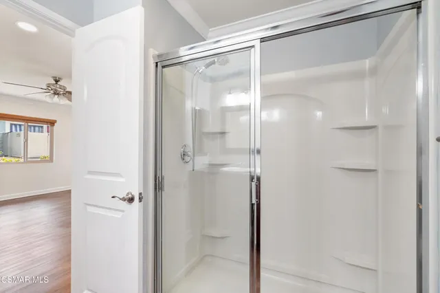 a bathroom with a glass shower door