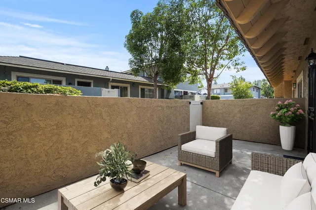 a balcony with couple of flower plants