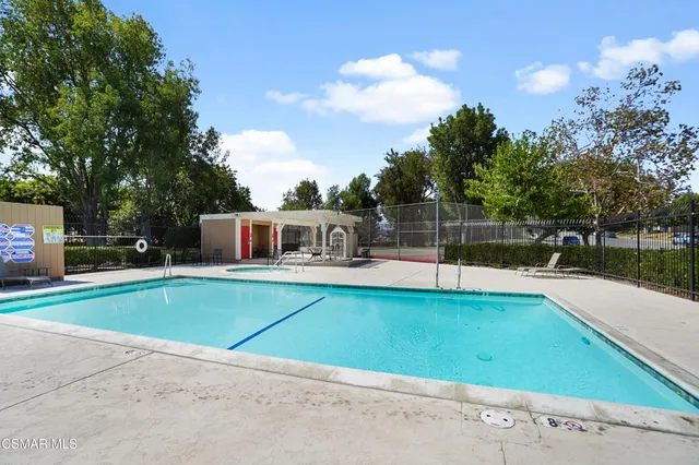 a house view with a swimming pool and sitting space