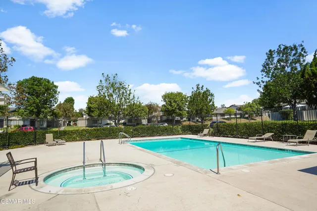 a swimming pool with an outdoor seating and yard