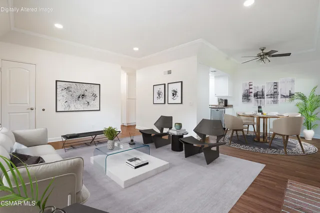 a living room with furniture a rug and white walls