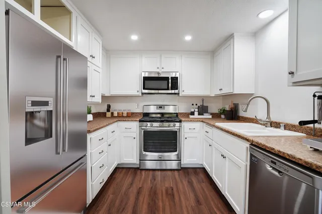 a kitchen with a sink stove and refrigerator