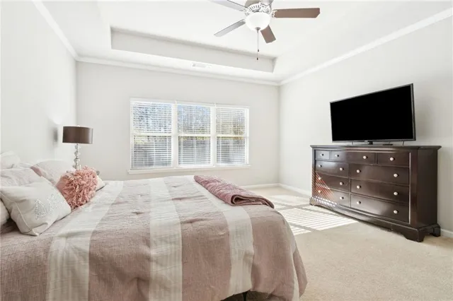 a bedroom with a bed and a ceiling fan