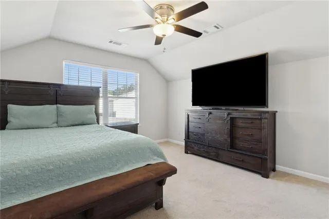 a bedroom with a bed and a television