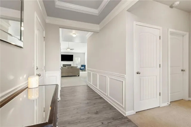 a view of a hallway with wooden floor and a window