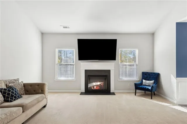 a living room with furniture a fireplace and a flat screen tv
