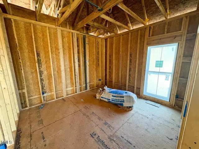 a view of a room with furniture and a window