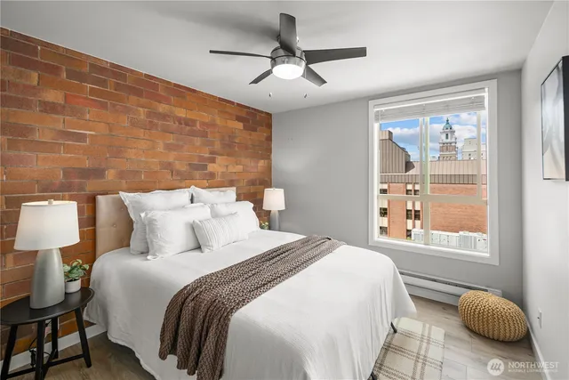 a bedroom with a bed and a ceiling fan