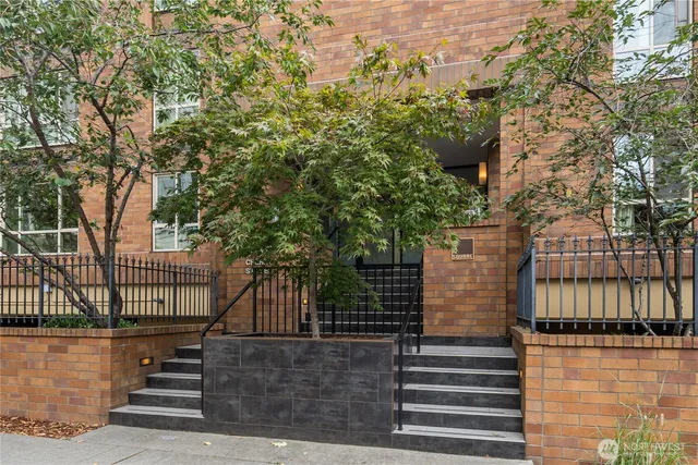a living room with furniture a mirror and a glass door shower