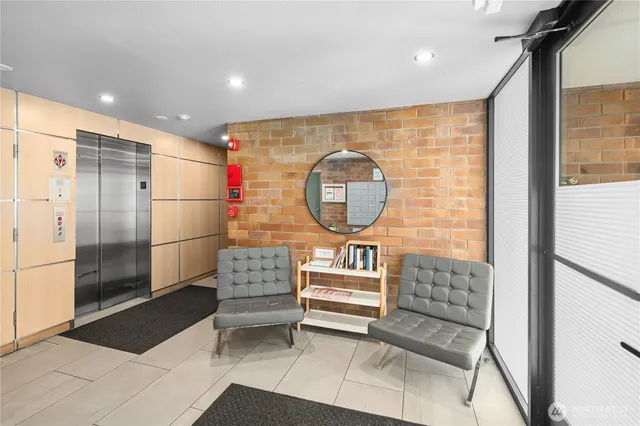 a kitchen with stainless steel appliances granite countertop a stove top oven a sink a dining table and chairs with wooden floor