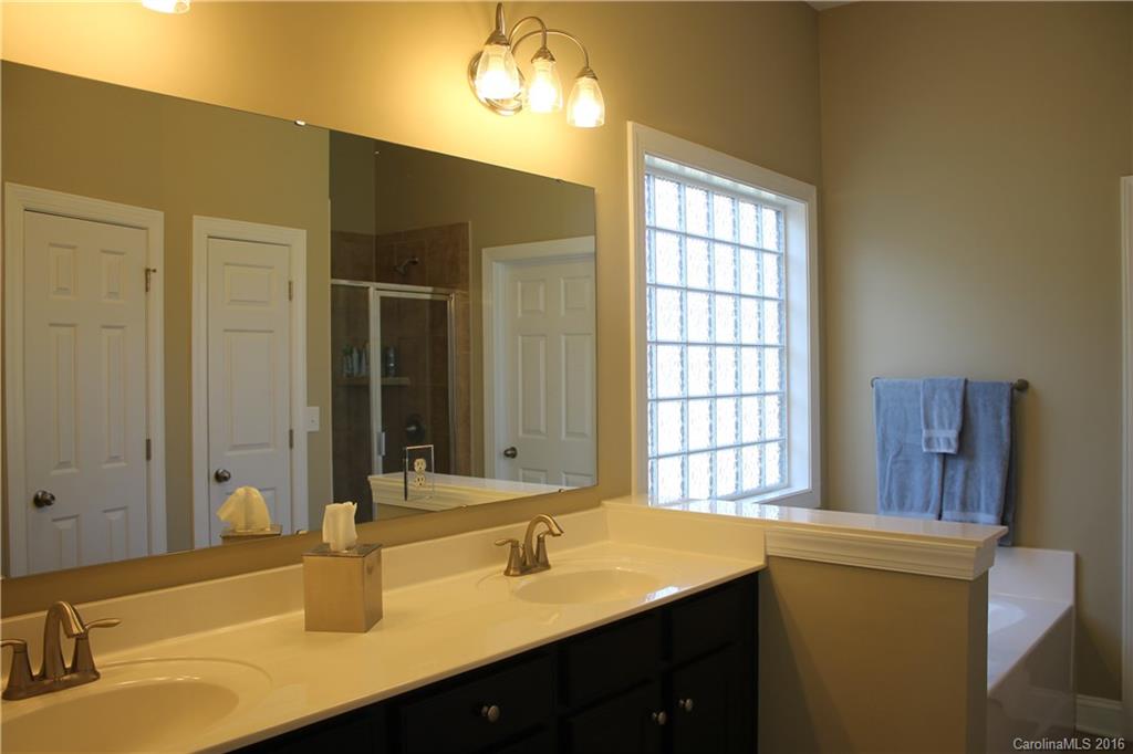 724 Revival Row Fort Mill, SC 29708 - Photo 11 of 15 a bathroom with a double vanity sink and a mirror