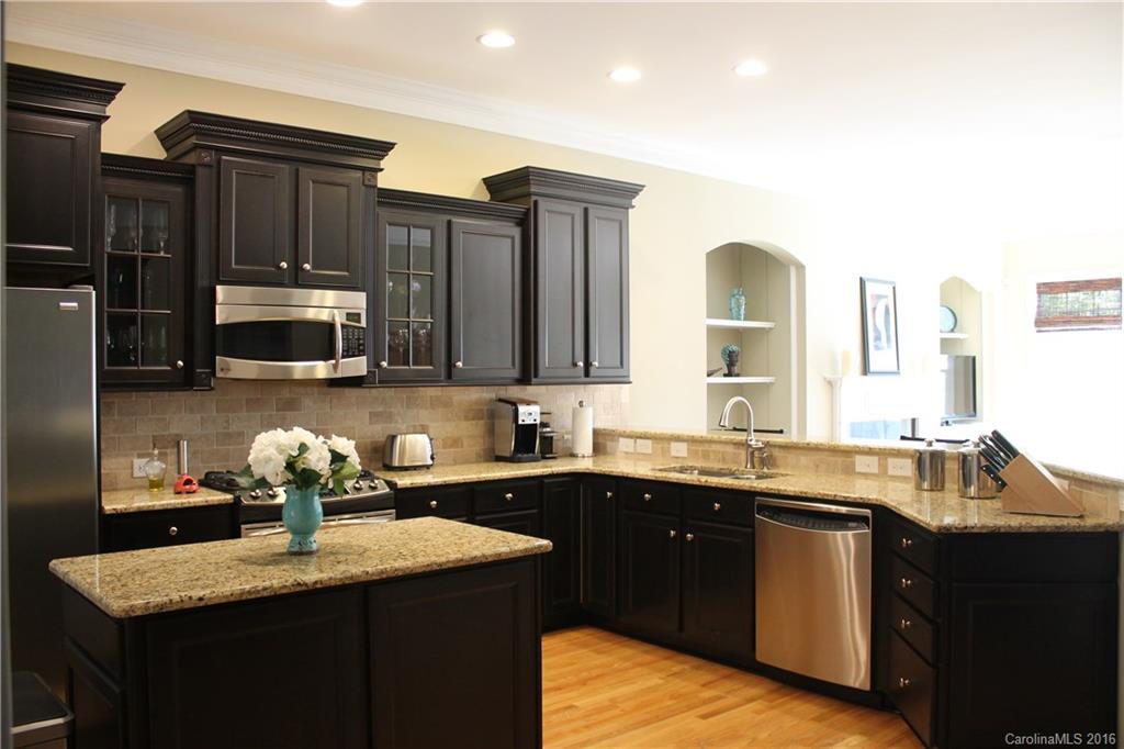 724 Revival Row Fort Mill, SC 29708 - Photo 3 of 15 a kitchen with stainless steel appliances granite countertop a sink stove and refrigerator