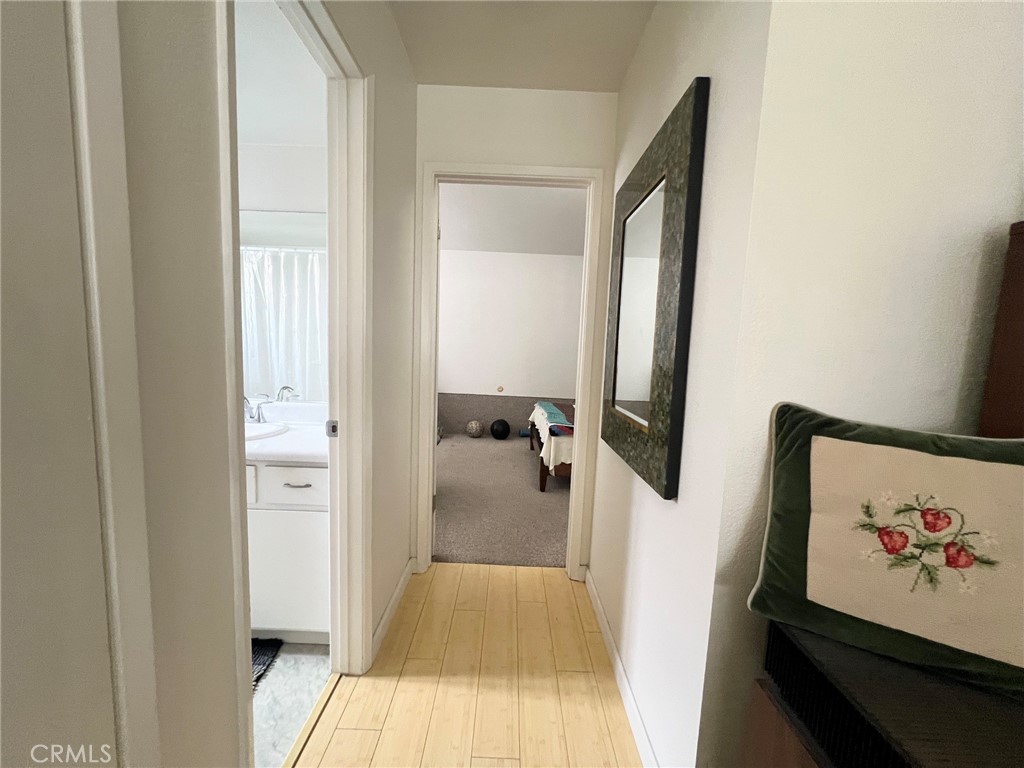 375 Surf Street Morro Bay, CA 93442 - Photo 16 of 25 a hallway with a view of bedroom with wooden floor