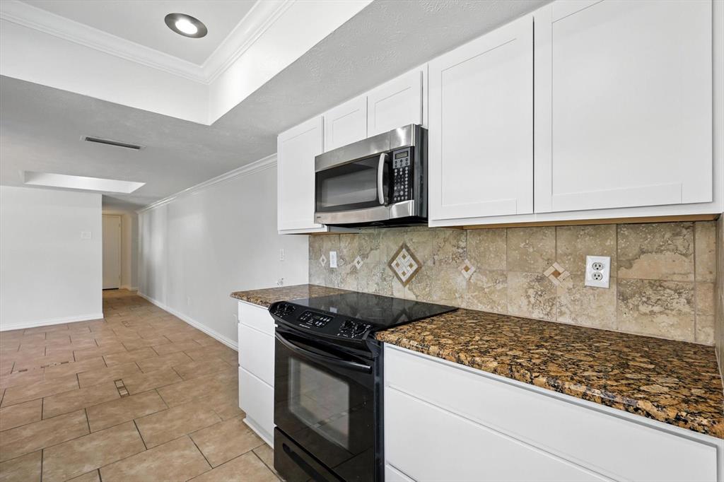 5024 Middleton Circle The Colony, TX 75056 - Photo 16 of 30 a kitchen with stainless steel appliances granite countertop white cabinets and stove