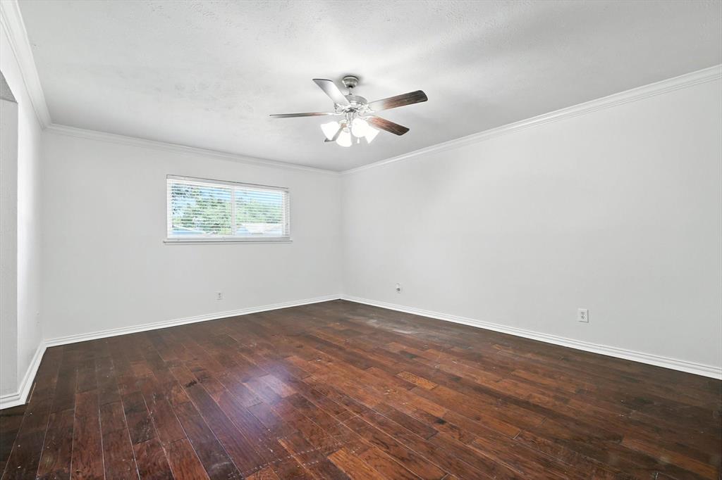 5024 Middleton Circle The Colony, TX 75056 - Photo 18 of 30 a view of an empty room with wooden floor and a ceiling fan