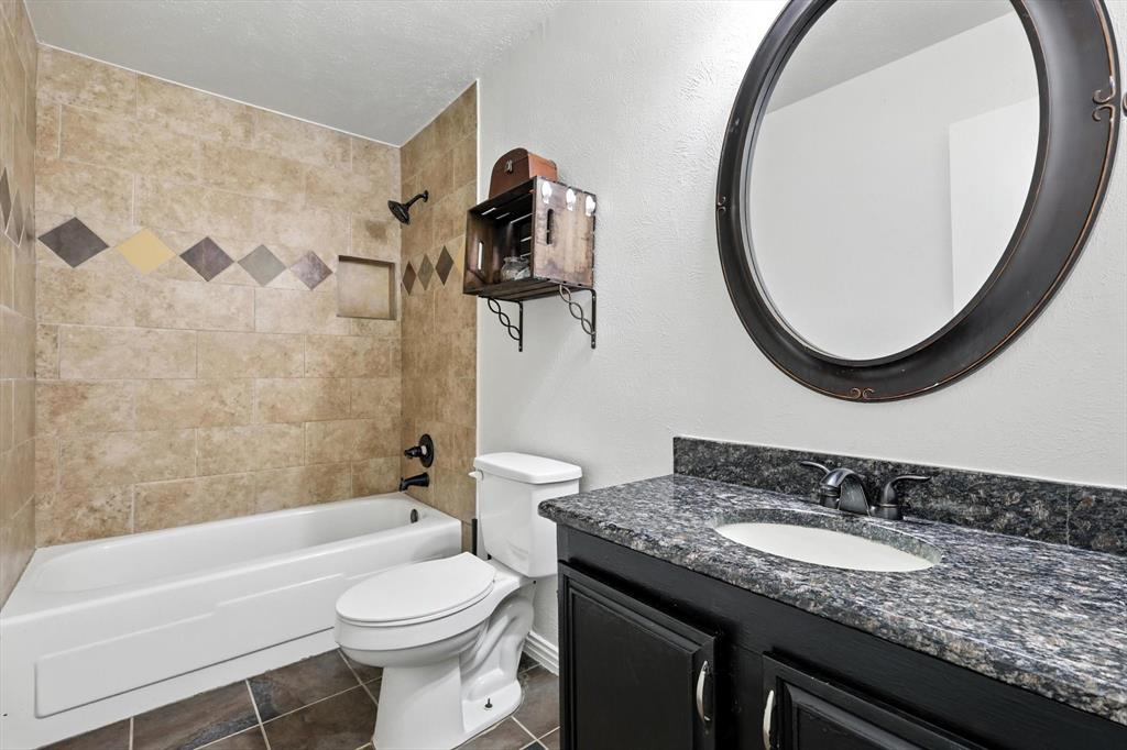 5024 Middleton Circle The Colony, TX 75056 - Photo 23 of 30 a bathroom with a granite countertop sink and a mirror