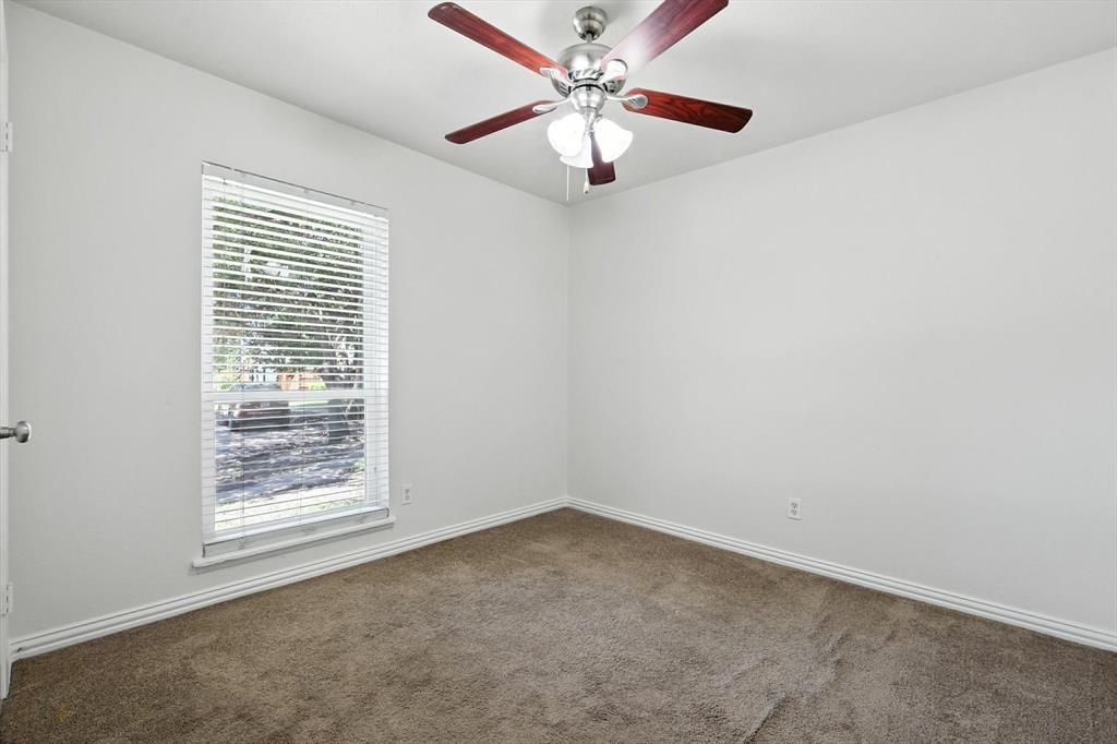 5024 Middleton Circle The Colony, TX 75056 - Photo 24 of 30 an empty room with windows and fan