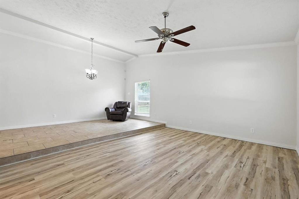 5024 Middleton Circle The Colony, TX 75056 - Photo 6 of 30 a bedroom with a bed and a chandelier