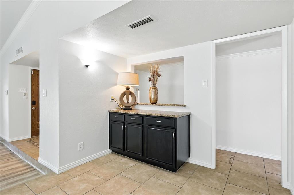 5024 Middleton Circle The Colony, TX 75056 - Photo 8 of 30 a kitchen with a sink and a refrigerator