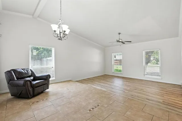 a view of livingroom with furniture chandelier and a window