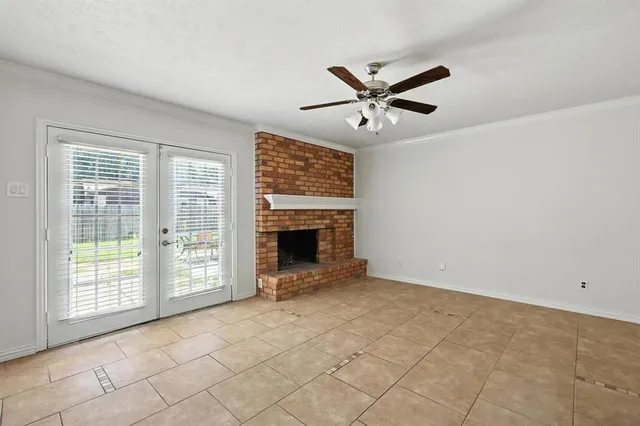 a view of an empty room with a fireplace and a window