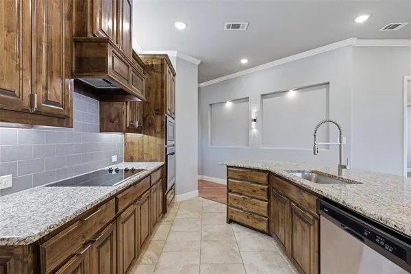 a kitchen with stainless steel appliances granite countertop a refrigerator and a sink