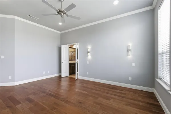 a view of an empty room with glass door and windows