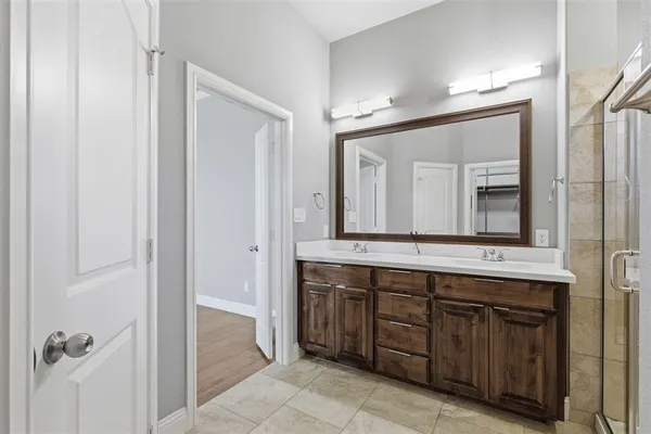 a bathroom with a shower sink and mirror
