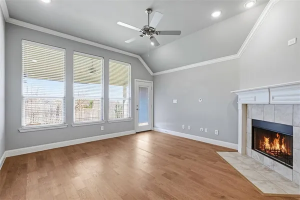 a view of an empty room with a fireplace and a window