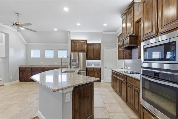 a kitchen with stainless steel appliances granite countertop a sink and a stove