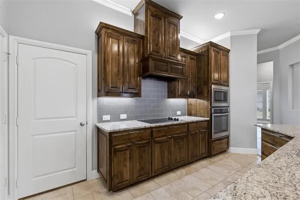 a kitchen with a sink appliances and cabinets