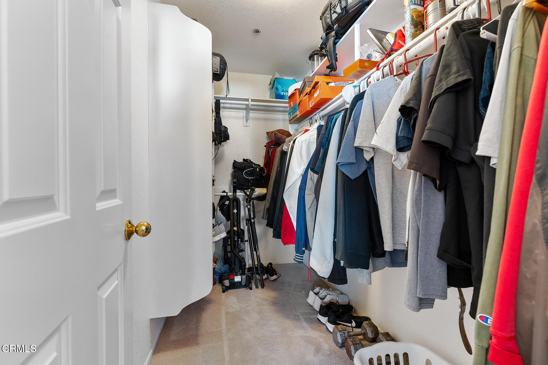 697 Sutton Crest Trail, Unit 304 Oak Park, CA 91377 - Photo 13 of 21 a view of walk in closet with clothes and shoes