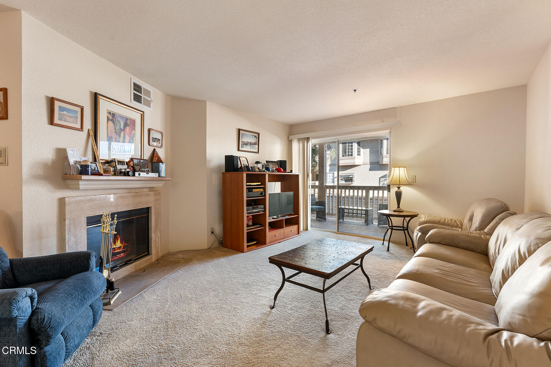 697 Sutton Crest Trail, Unit 304 Oak Park, CA 91377 - Photo 2 of 21 a living room with furniture and a fireplace