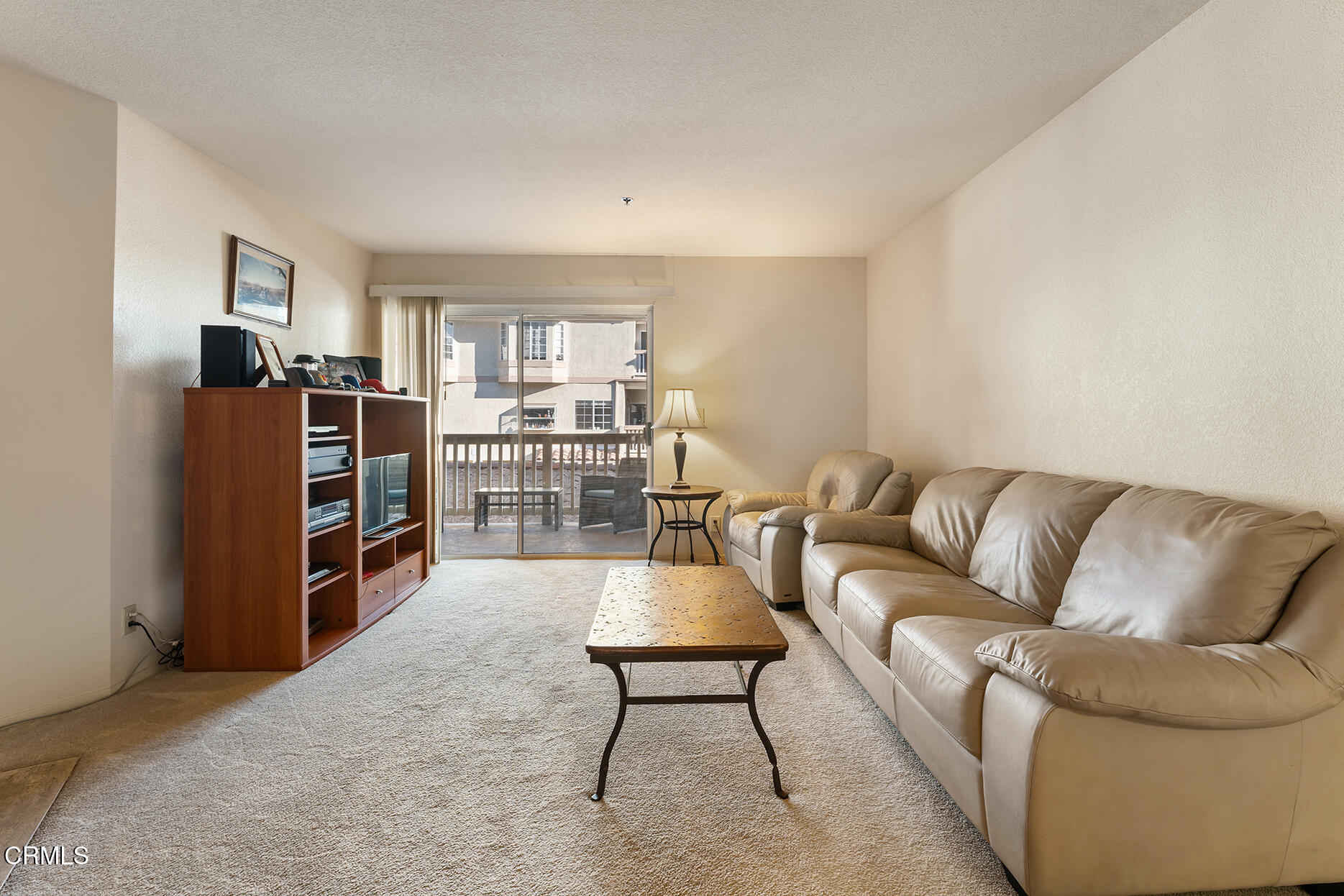 697 Sutton Crest Trail, Unit 304 Oak Park, CA 91377 - Photo 3 of 21 a living room with furniture and a flat screen tv