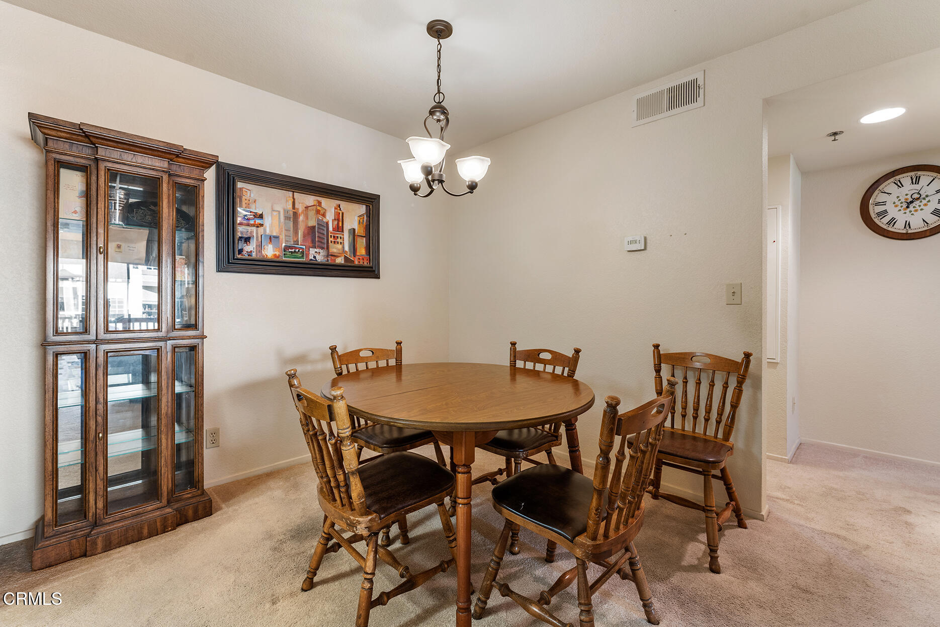 697 Sutton Crest Trail, Unit 304 Oak Park, CA 91377 - Photo 5 of 21 a view of a dining room with furniture and chandelier