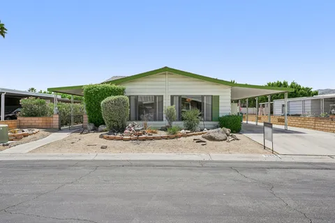 a view of a house with backyard porch and sitting area