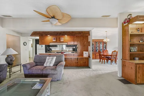 a living room with furniture and a dining table