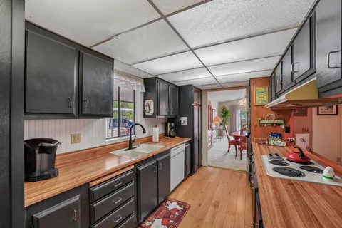a kitchen with stainless steel appliances granite countertop a sink stove and cabinets