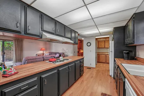 a kitchen with stainless steel appliances a sink stove and refrigerator