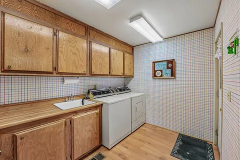 a view of a storage & utility room with a sink