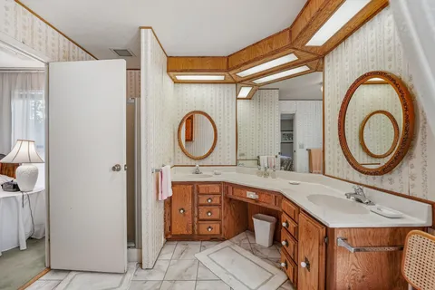 a bathroom with a double vanity sink and a mirror