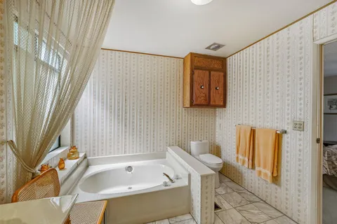 a bathroom with a tub and shower
